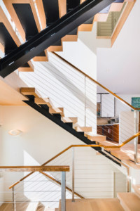 modern floating stair with i-beam stringer and cable rails