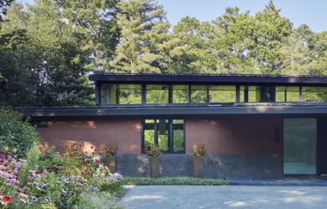 Modern House in the Woods, high clerestory windows admit light between roofs